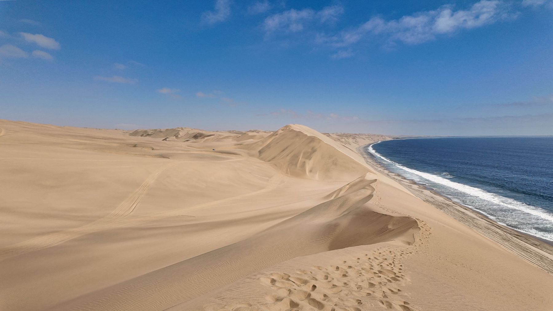 Giant sand dunes running into the Atlantic Ocean in Namibia